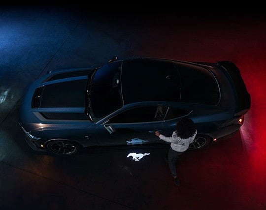 2024 Ford Mustang® Dark Horse™ model with a driver approaching the vehicle | Freedom Ford Greenville by Ed Morse in Greenville TX